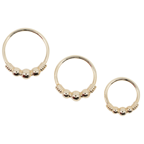 Three yellow gold seam rings in different diameters. Each ring has the decorative portion of beads and wire.