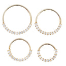 Four yellow gold seam rings with a row of 1mm white round prong set CZ's showing four different diameters.