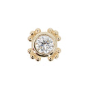 Yellow gold push pin earring with a round white diamond in a bezel setting. there are four accents around the bezel, each mad of three beads.