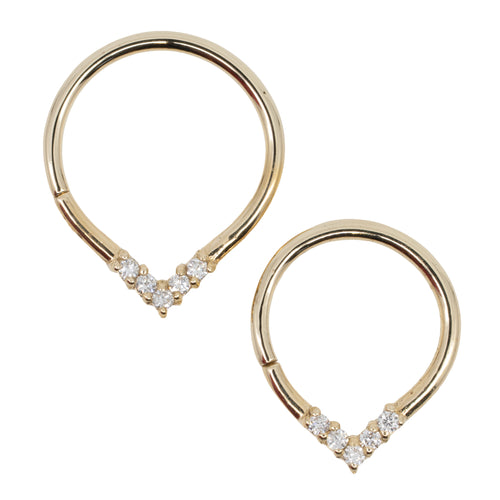 Two yellow gold teardrop seam rings with five round white diamonds at the apex. Two different diameters.