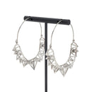 A pair of silver plated hoop earrings with the decorative portion created by varying sizes of hollow triangles.
