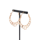 A pair of rose gold plated hoop earrings with the decorative portion created with hollow rectangles and squares.