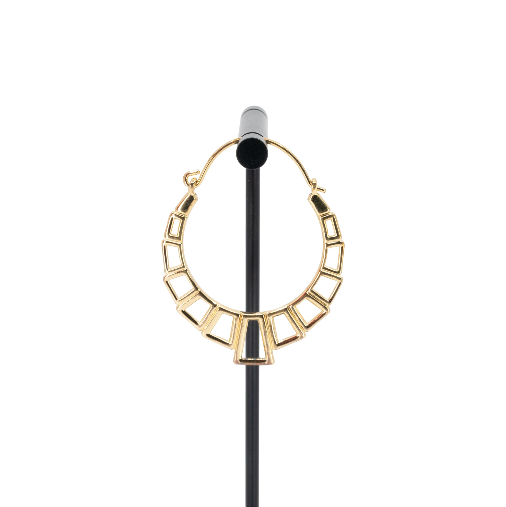 A single yellow gold plated hoop earring with the decorative portion created with hollow rectangles and squares.