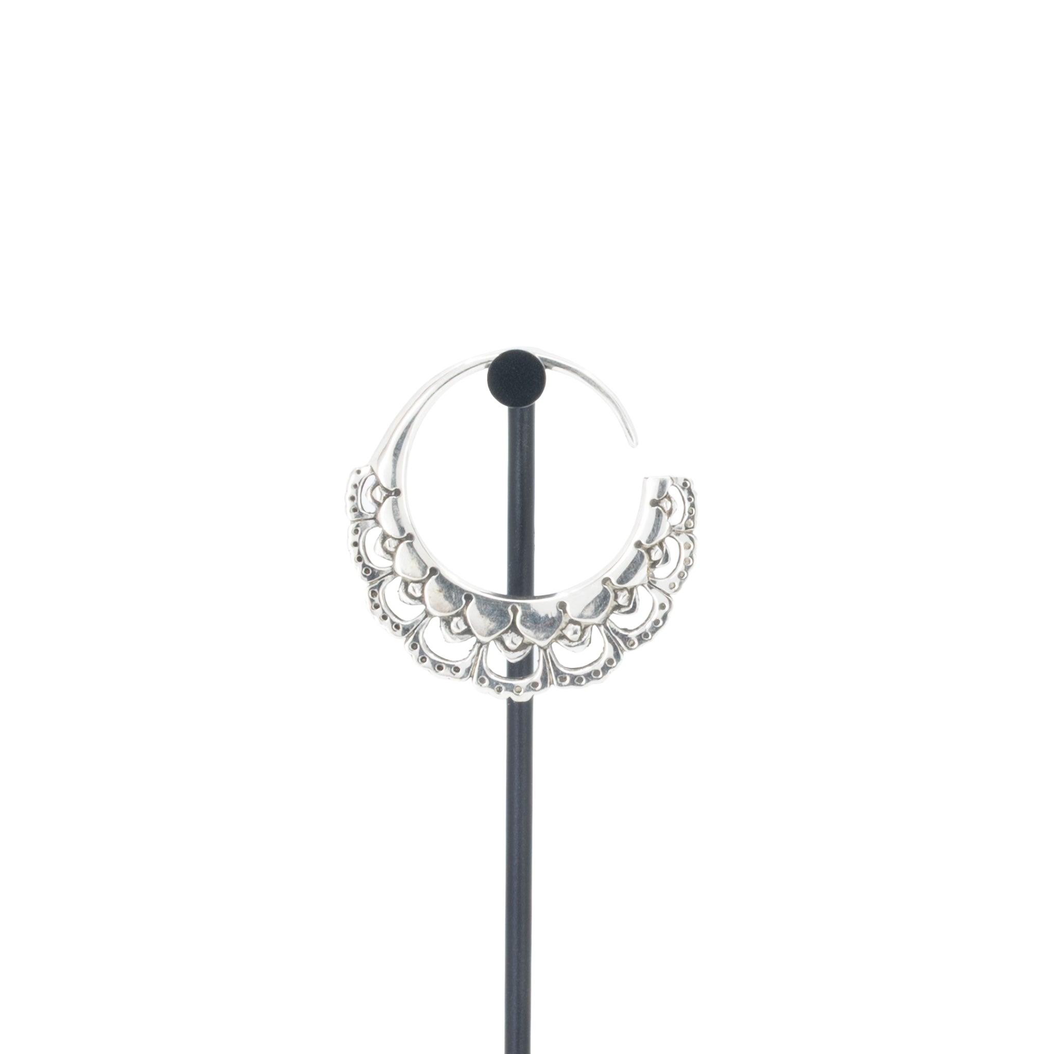 A single silver hoop earrings with flower petal details.