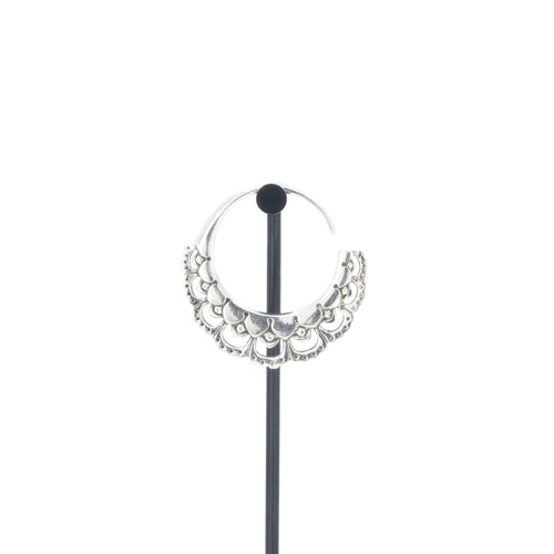 A single silver hoop earrings with flower petal details.