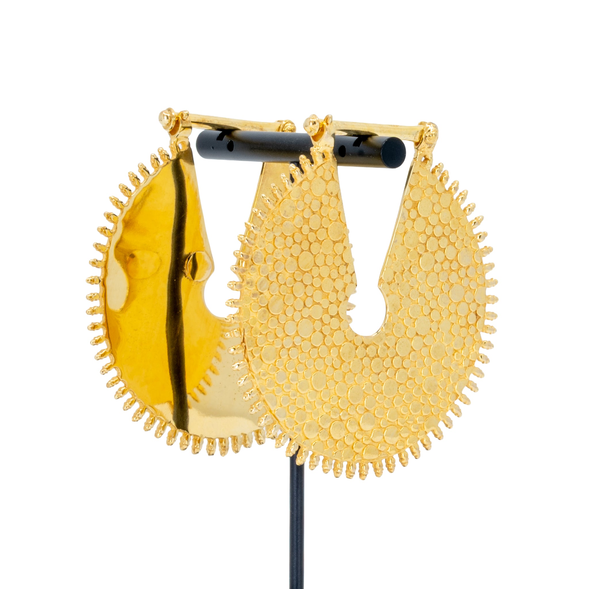 A pair of large yellow gold weights with a  textured dotted surface and scalloped edge.