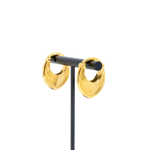 A pair of yellow gold plated weights in a soft teardrop shape with a laser etched line pattern on the outside.