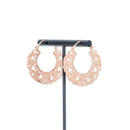 A pair of rose gold plated hoop earrings with decorative scroll work accents.