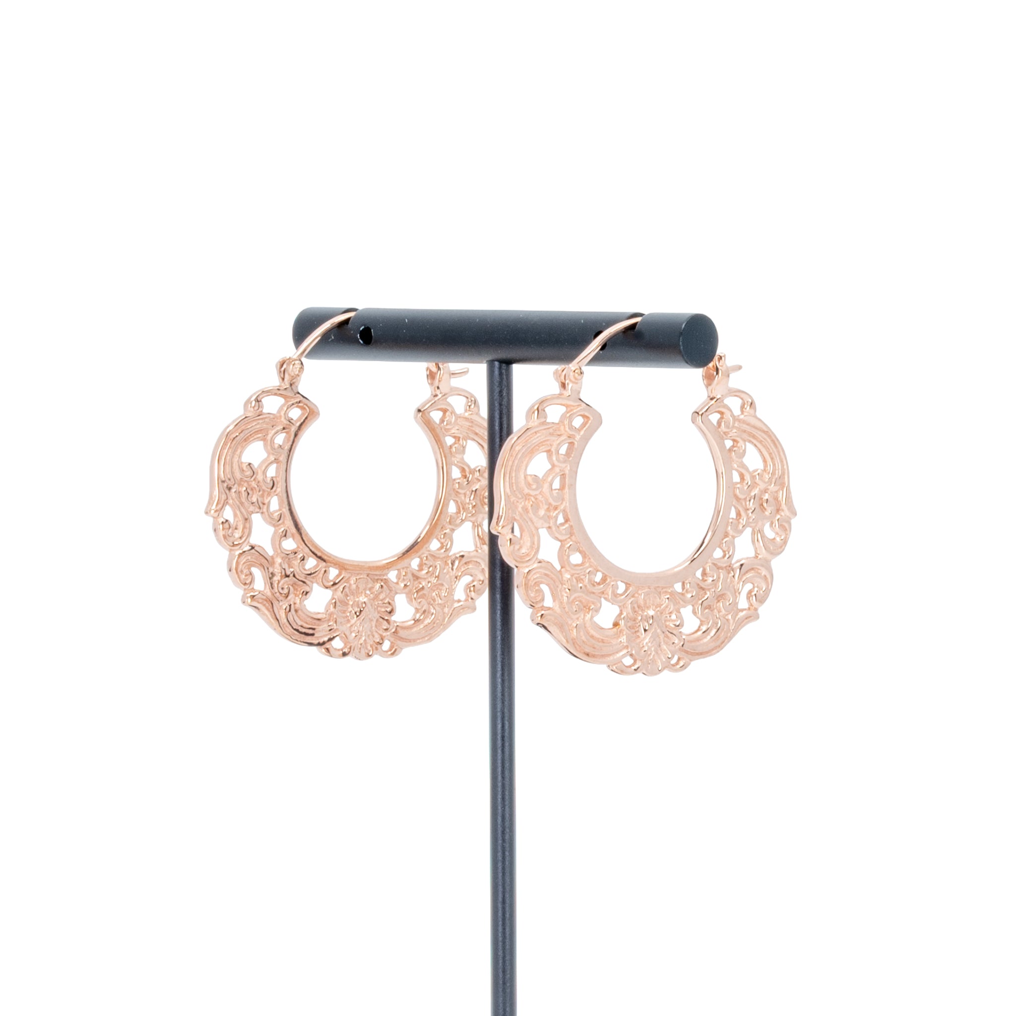 A pair of rose gold plated hoop earrings with decorative scroll work accents.