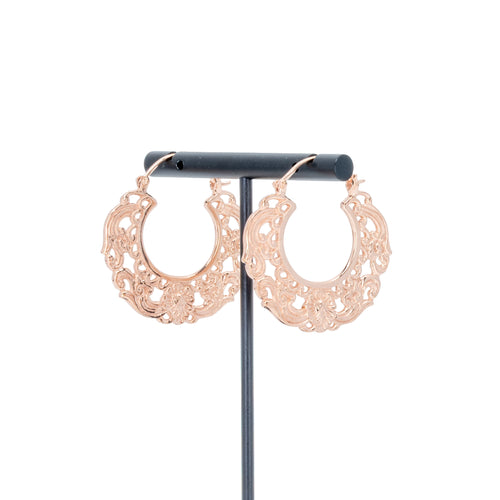 A pair of rose gold plated hoop earrings with decorative scroll work accents.