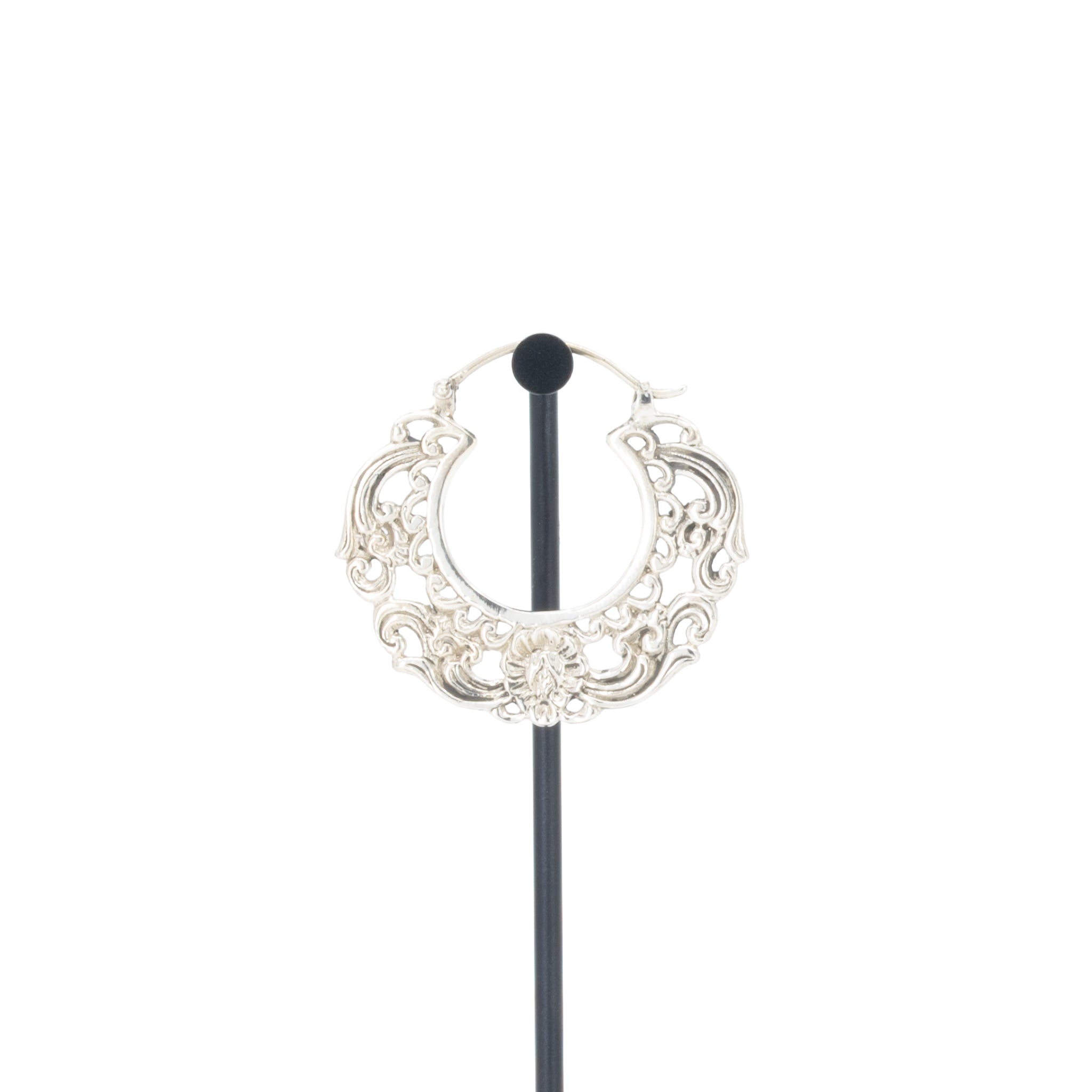 A single silver hoop earrings with decorative scroll work accents.