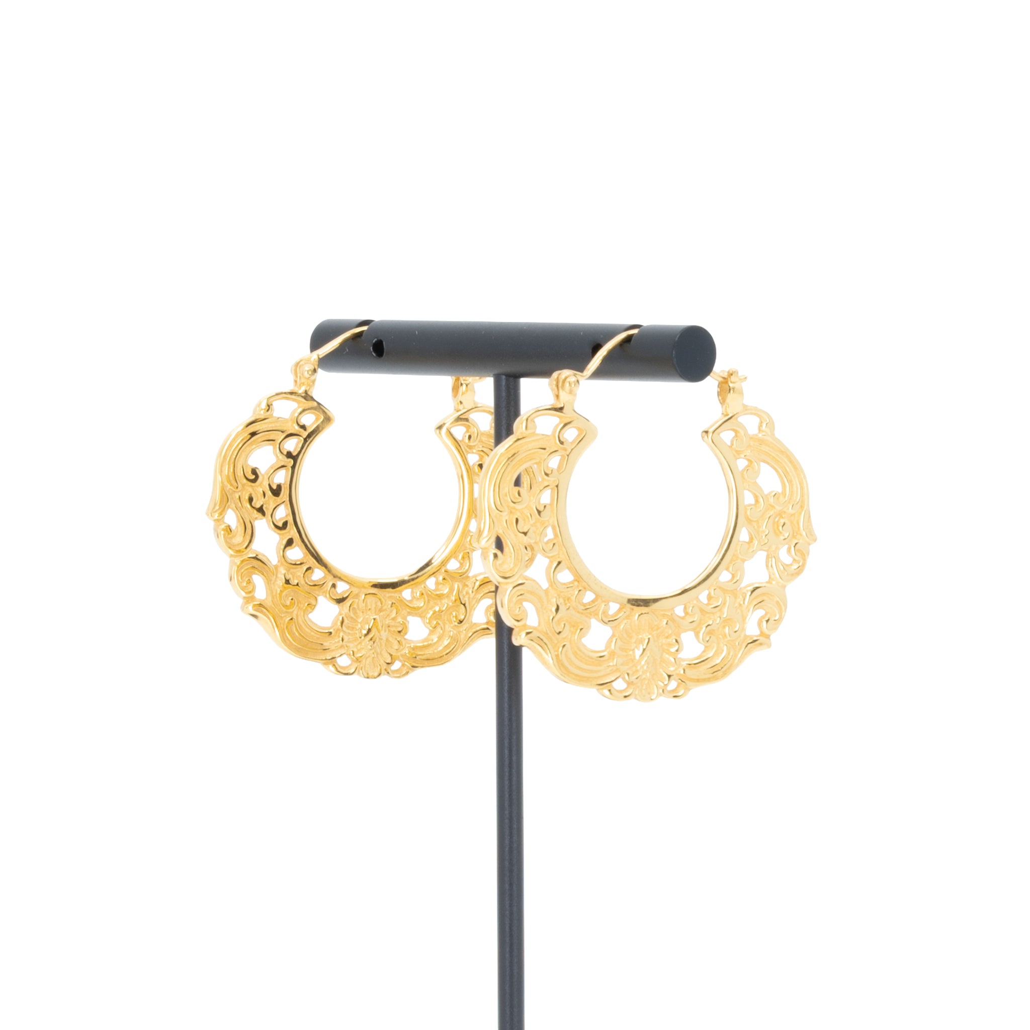 A pair of yellow gold plated hoop earrings with decorative scroll work accents.