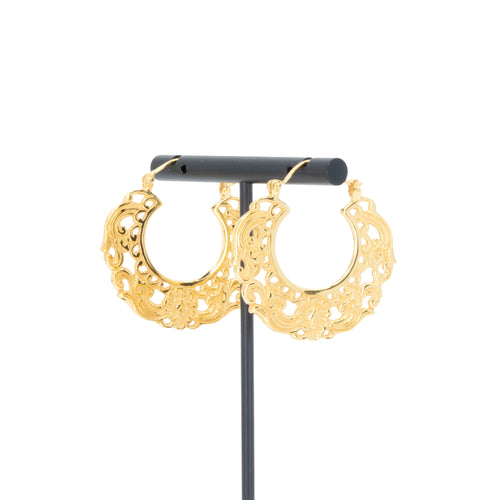 A pair of yellow gold plated hoop earrings with decorative scroll work accents.