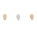 Three teardrop shaped push pin earrings each with two prong set round white diamonds. One yellow gold, one white gold, and one rose gold.