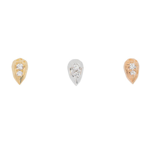 Three teardrop shaped push pin earrings each with two prong set round white diamonds. One yellow gold, one white gold, and one rose gold.