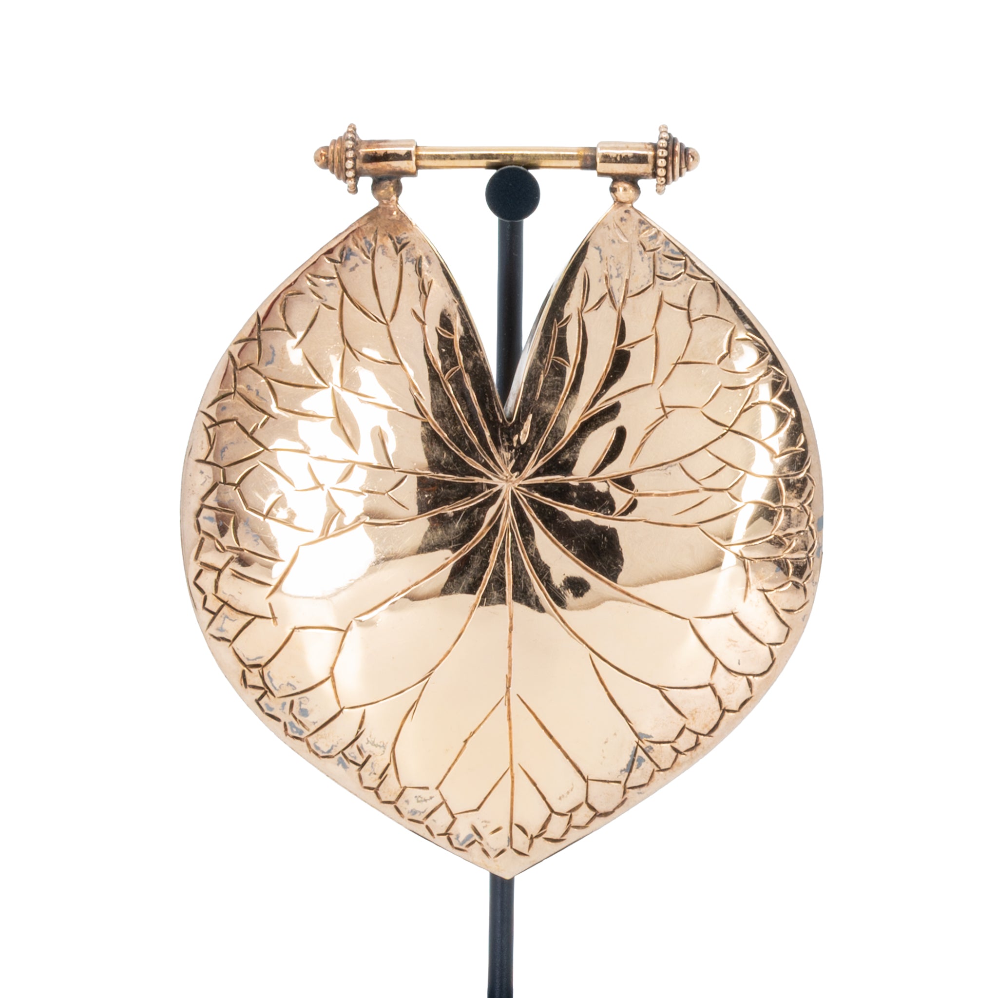 A large leaf-shaped rose gold weights with intricate engraved vein patterns.