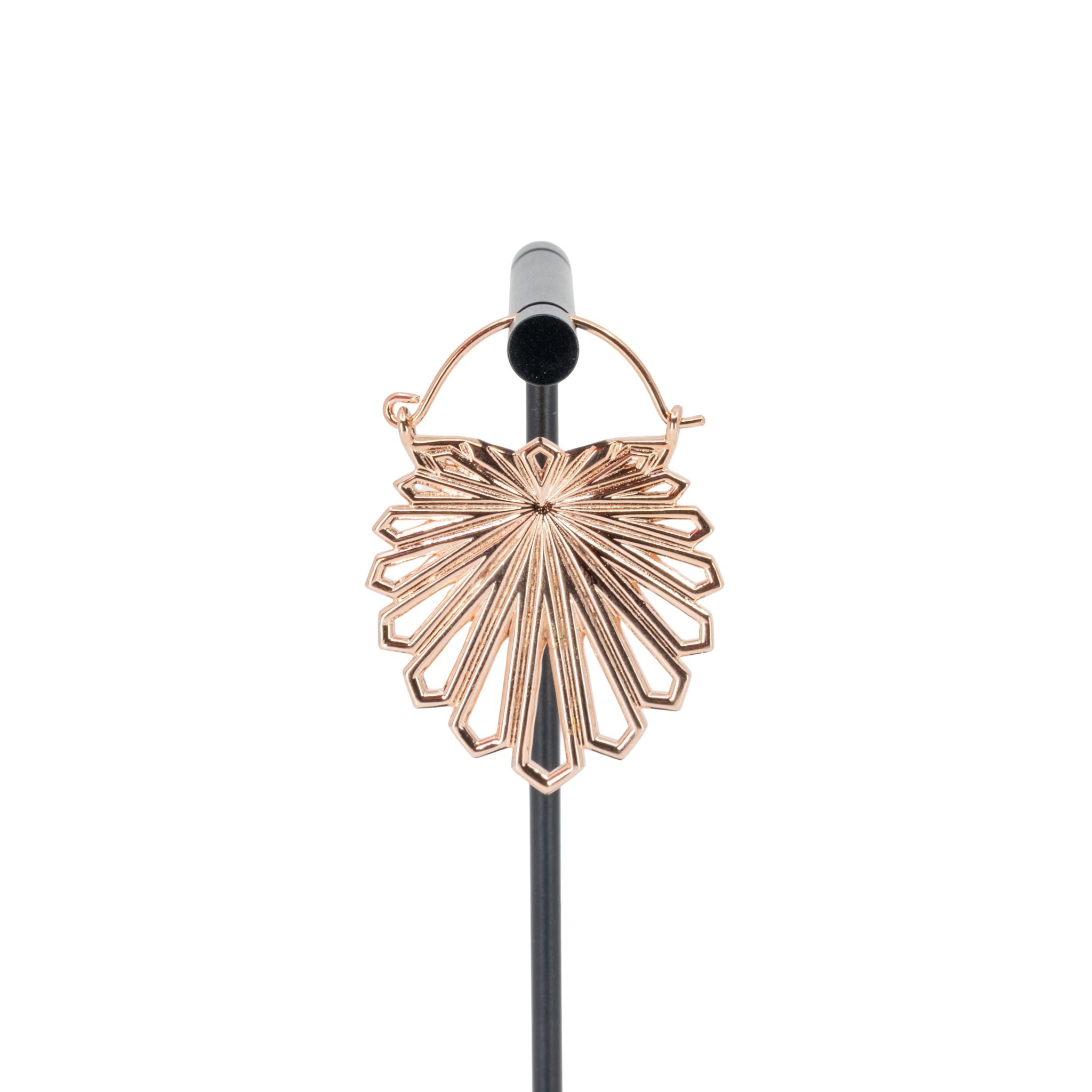 A rose gold plated hoop earring with a floral design that uses kite shapes to create the petals.