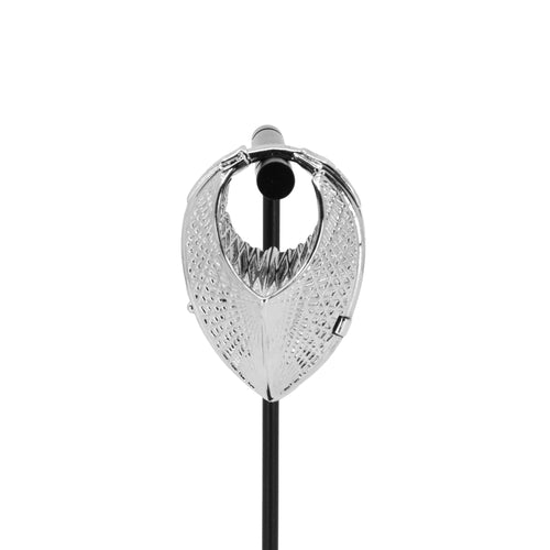 A single white bronze weight in a teardrop shape with a laser etched geometric pattern on the outside.