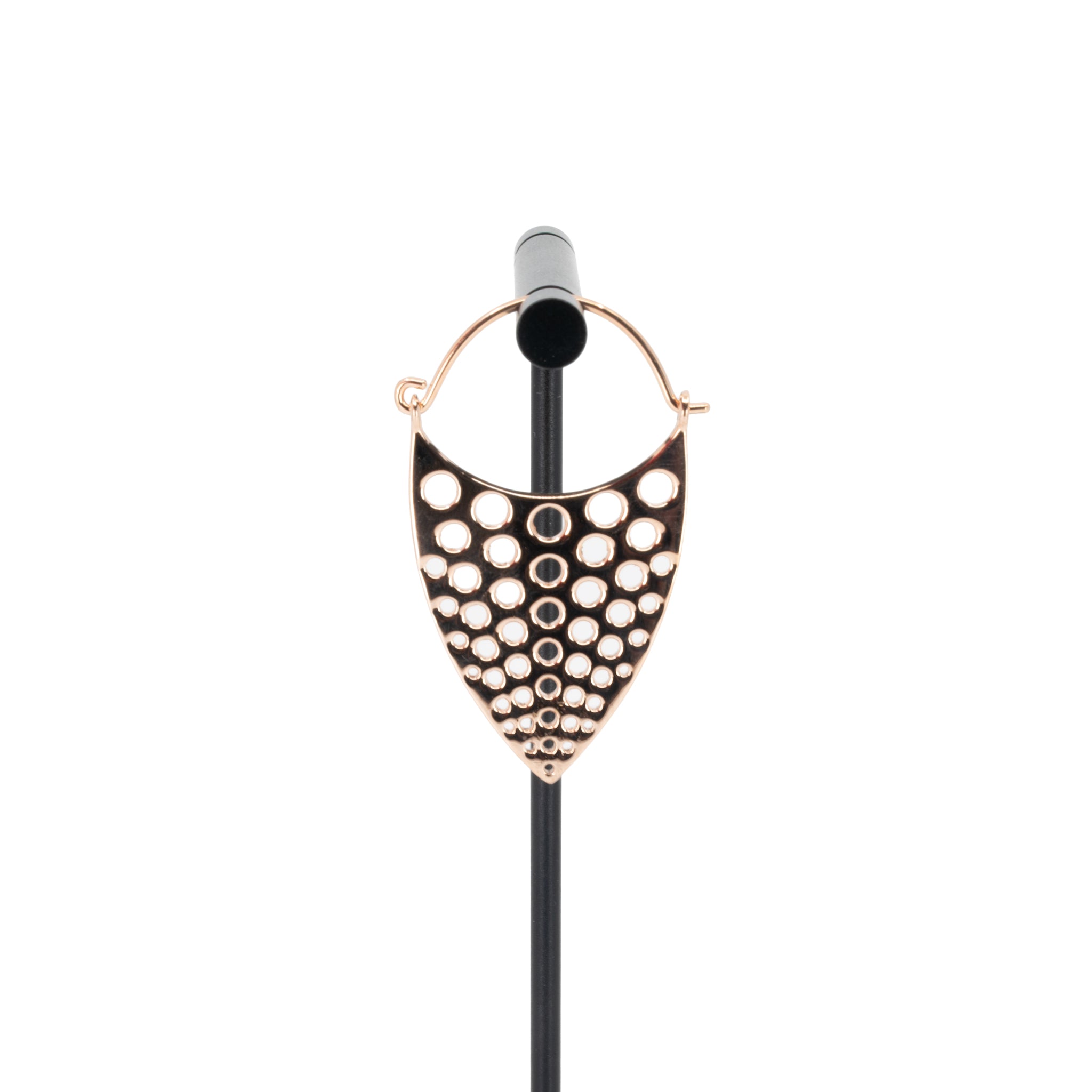 A single rose gold plated hoop earring with a teardrop design that has hole cutouts.