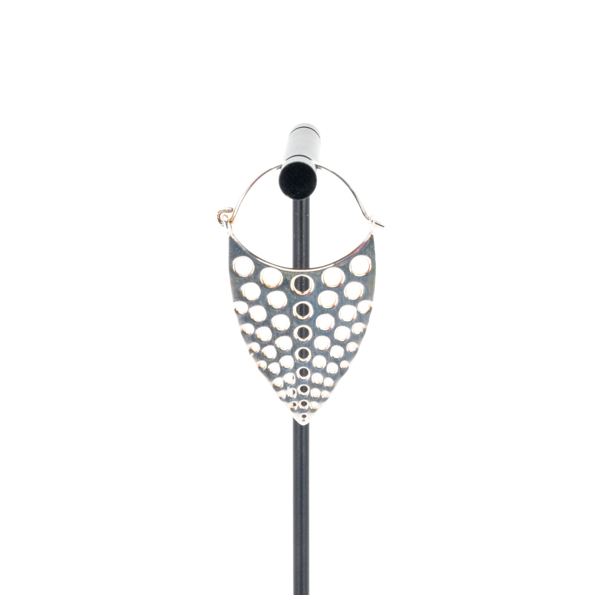 A single silver plated hoop earring with a teardrop design that has hole cutouts.