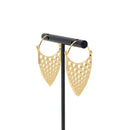 A pair of yellow gold plated hoop earrings with a teardrop design that has hole cutouts.