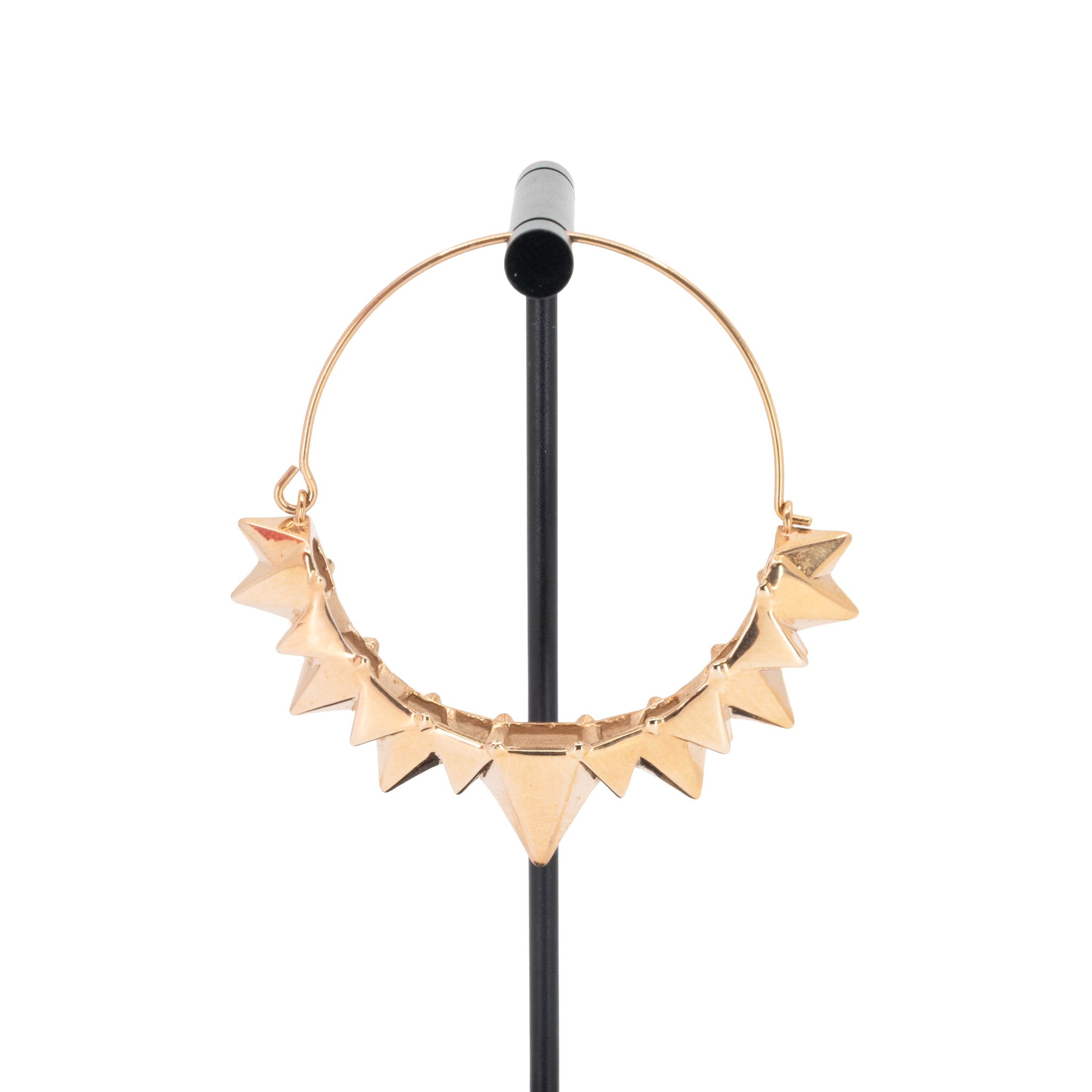 A single rose gold plated hoop earring with the decorative portion created by varying sizes of solid triangles.