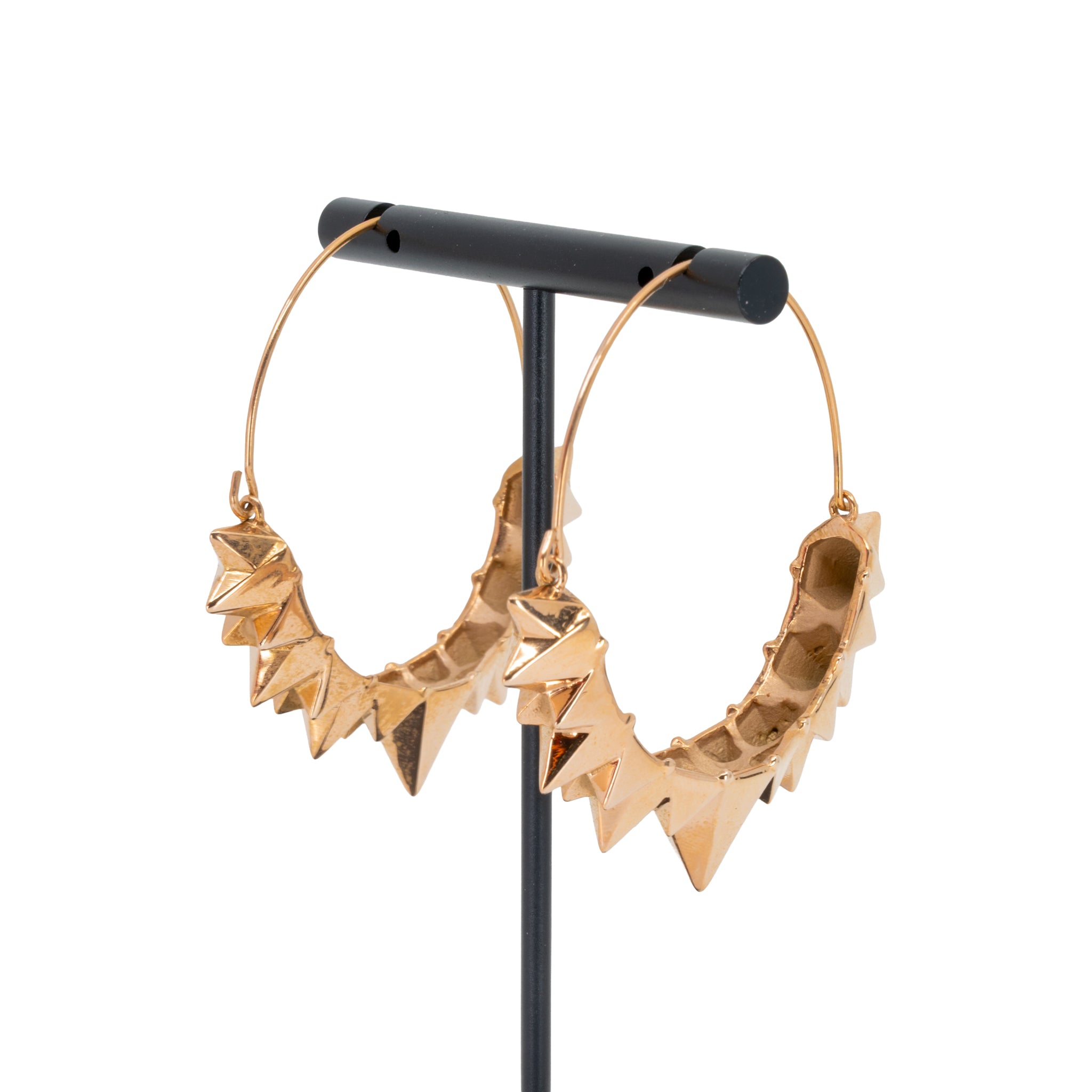 A pair of rose gold plated hoop earrings with the decorative portion created by varying sizes of solid triangles.