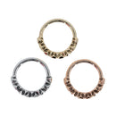 Three seam rings with a geometric decorative portion created with a row of engraved three point stars. One yellow gold, one white gold, and one rose gold.