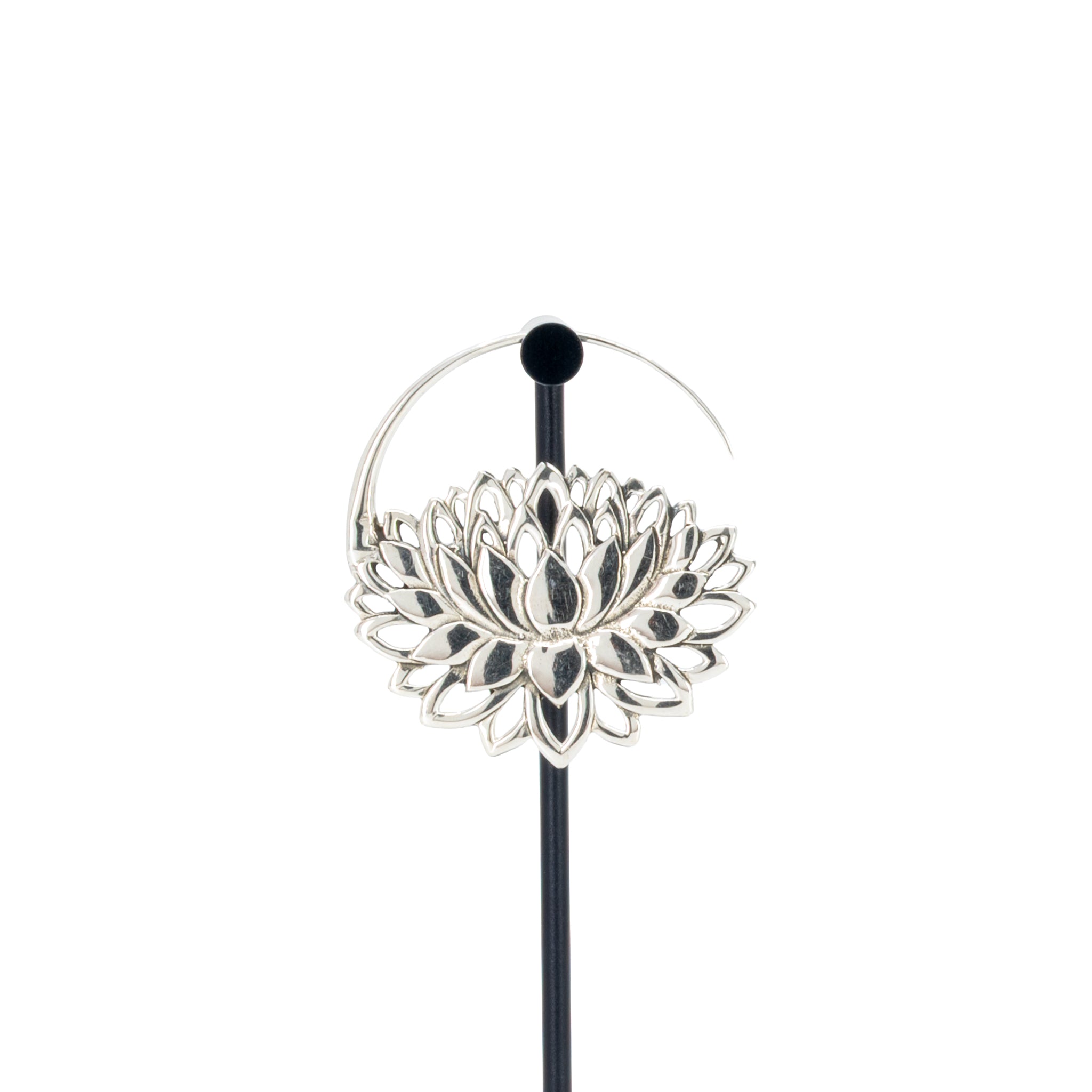 A single silver hoop earrings with a lotus at the bottom.