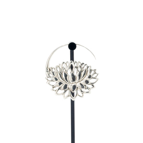 A single silver hoop earrings with a lotus at the bottom.