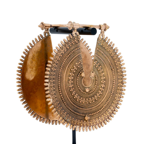 A pair of ornate rose gold weights with intricate concentric beadwork.