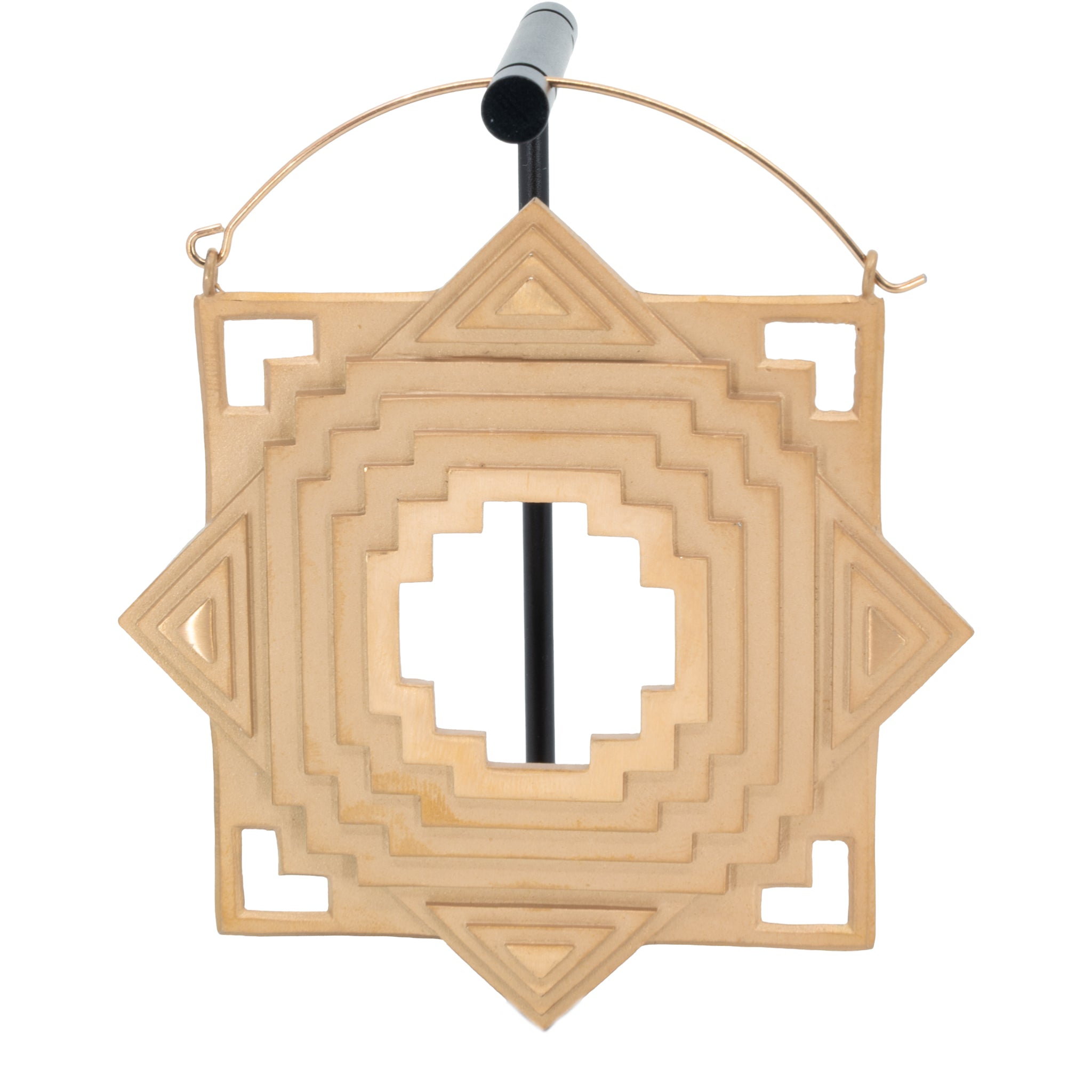 An extra large single rose gold plated hoop earring with a geometric design and a cut out in the center and in the four corners.