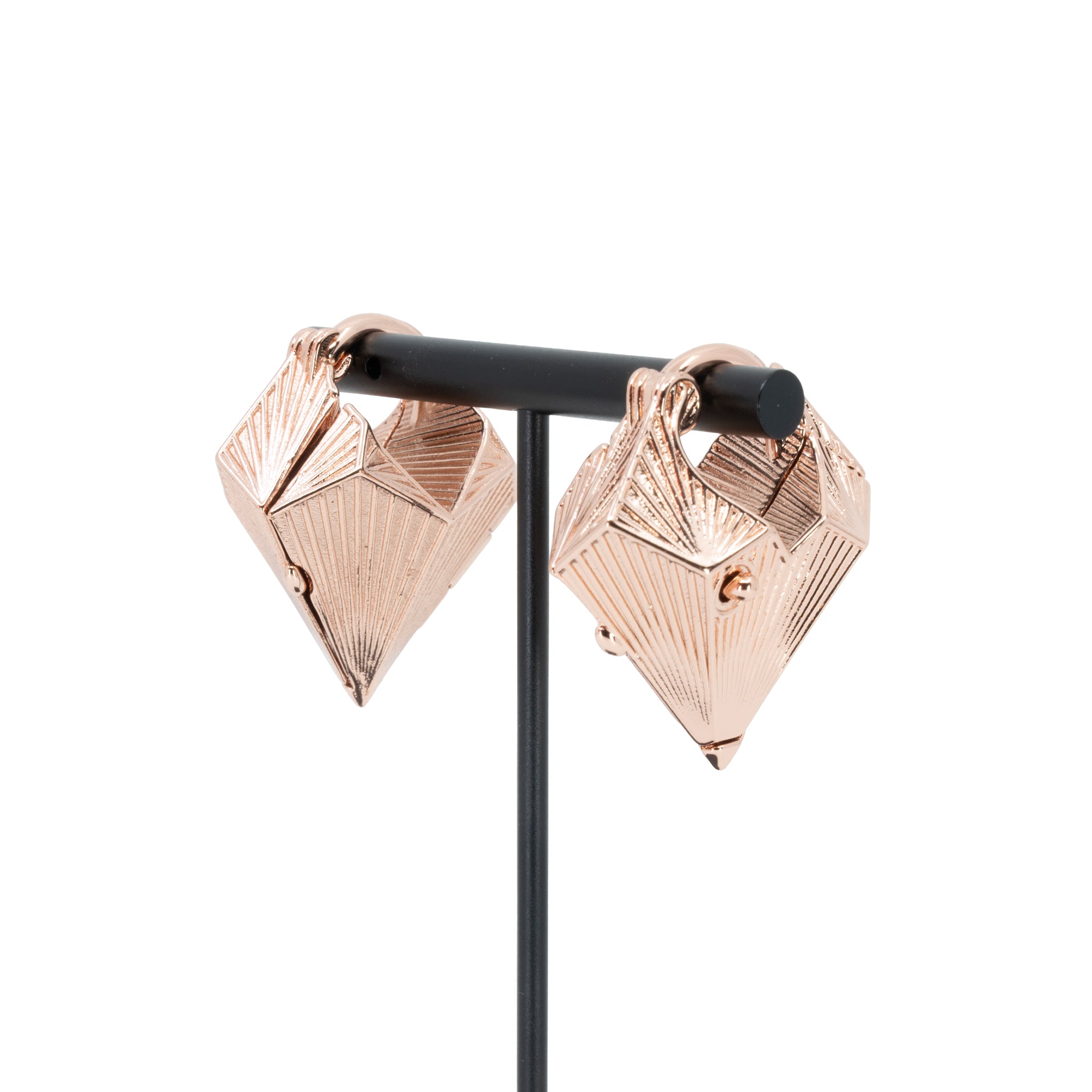 A pair of rose gold plated weights in a diamond shape with a laser etched geometric pattern on the outside.