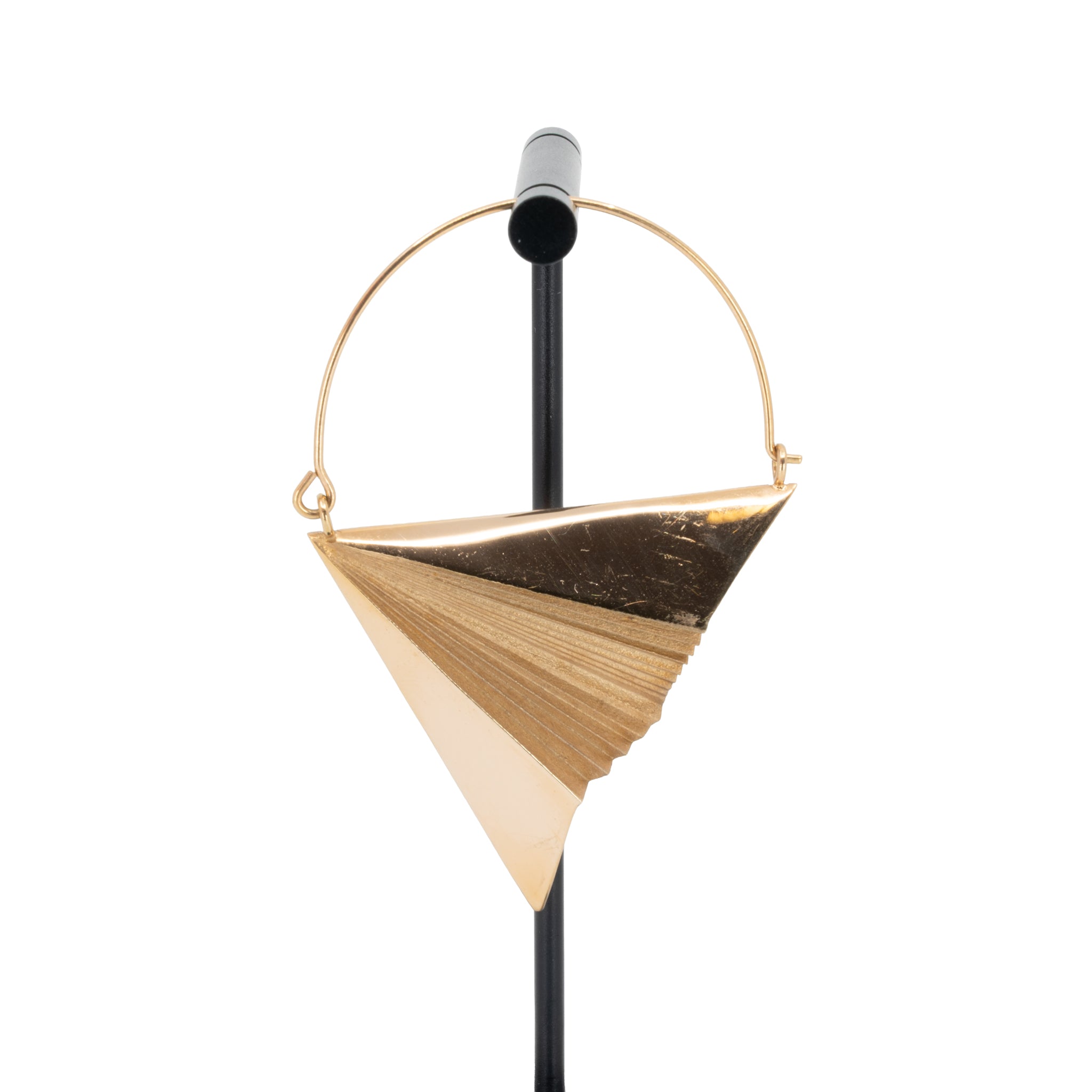 A single rose gold plated hoop earring in the design of a paper airplane.