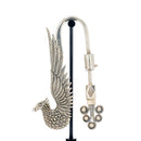 A silver weight with detailed phoenix designs.