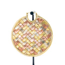 A large hoop earring with a woven herringbone pattern of copper, brass, and white brass.