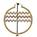 A large hoop earrings with horizontal bands of alternating brass, copper, and white brass chevron cutouts.